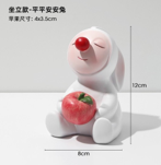 Seating clown with apple